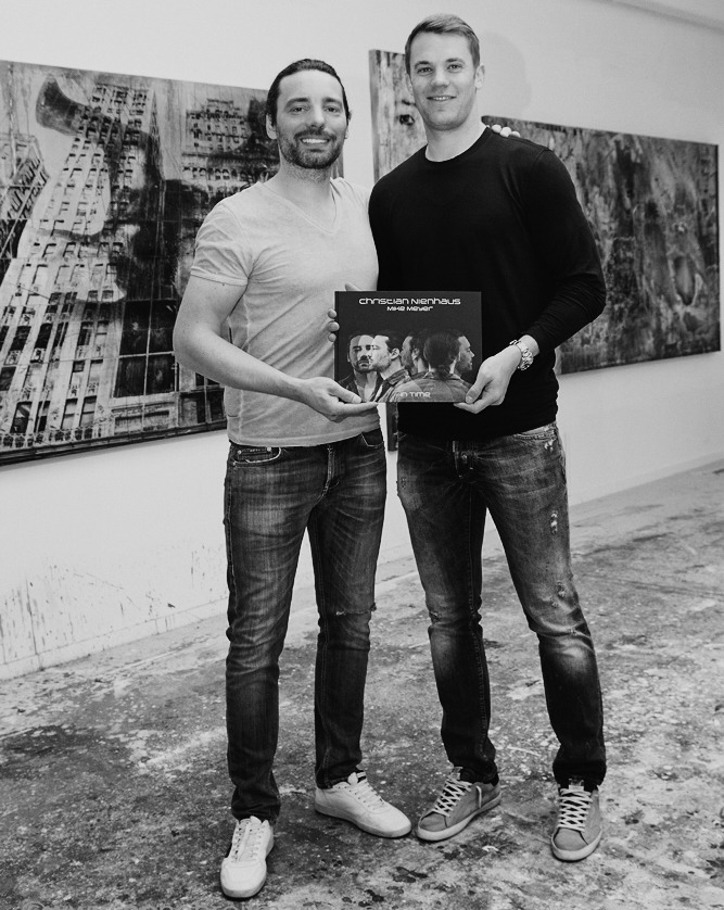 in time manuel neuer christian nienhaus with book in hands by Mike Meyer Photography